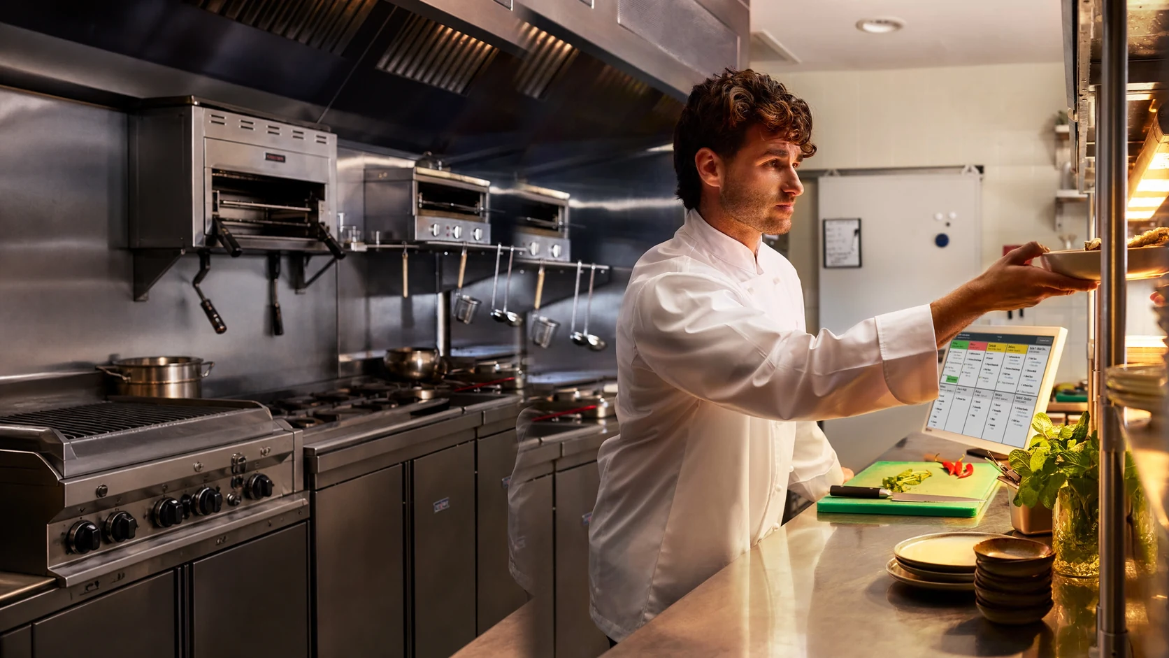 Restaurant kitchen team managing orders with a Clover Kitchen Display System